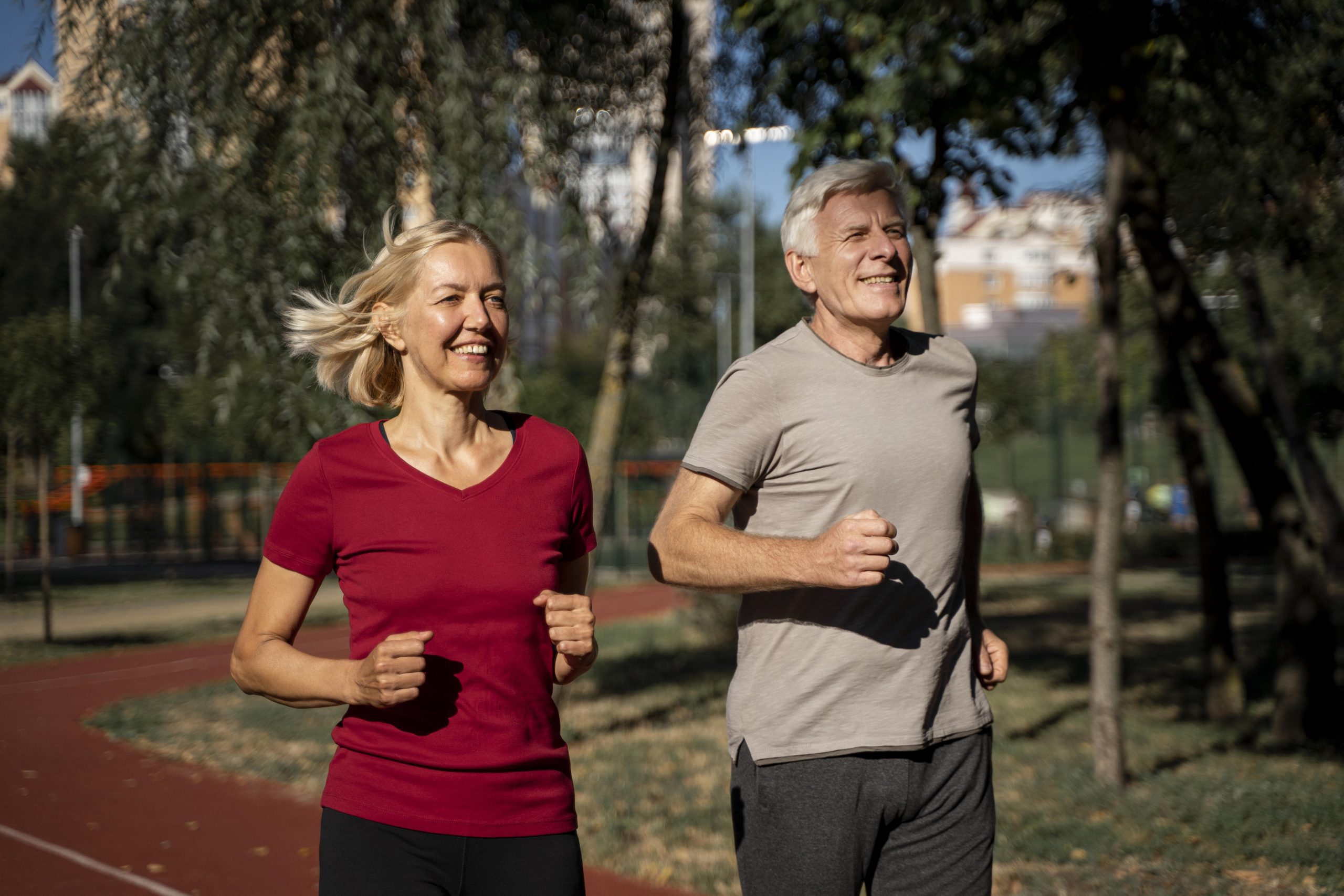 smiley-older-couple-jogging-outdoors-min